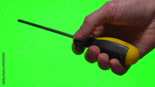 A metal screwdriver in a hand against an isolated background.
A close-up of a construction tool.
A device for driving screws and self-tapping screws.
