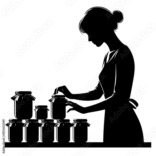 Woman canning homemade preserves in kitchen