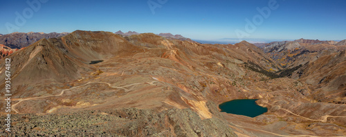 This scenic mountain panorama near Ouray, Colorado, features beautiful Lake Como with Hurricane Pass just above, and Corkscrew Gulch, decorated with colorful autumn aspen trees, below.