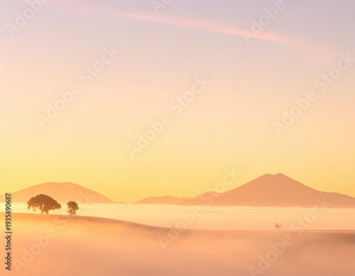 Serene Sunrise Over Misty Mountains and Silhouetted Trees