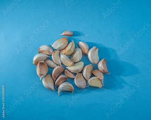 Fresh Garlic Cloves on Blue Background
