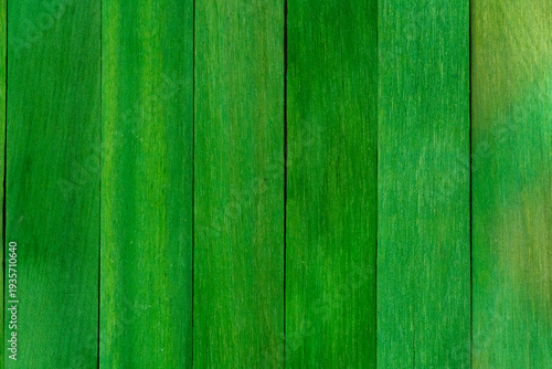 Vibrant green wood texture with vertical planks and natural grain, Bright green wooden board background for nature and spring design, Close-up of green painted timber panels with organic wood grain