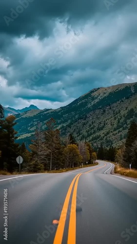 Mountain Road with Stormy Weather Conditions.