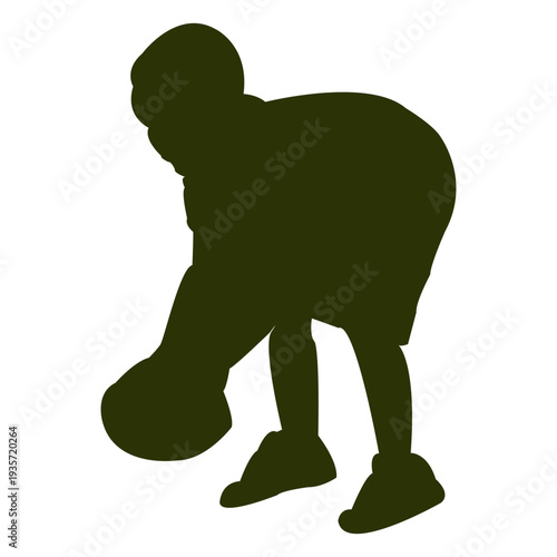 Boy picking ball silhouette on his side