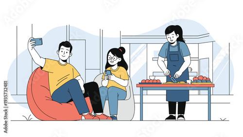 Friends spending time together in a modern home where one person takes a selfie while another prepares a meal at the dining table.