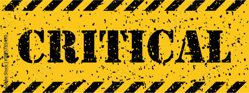 A grunge style yellow and black sign with stripes clearly states the important word CRITICAL