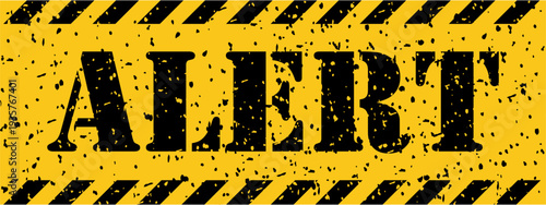 A vibrant yellow and black grunge textured warning sign clearly communicates the word ALERT