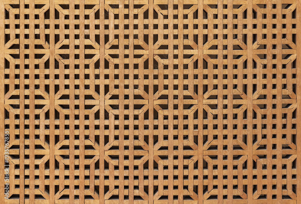 Naklejka premium Panjara background texture. Decorative wooden lattice screen with repeating geometric pattern and warm timber tones, ideal for Oriental architecture, interior design, backgrounds and textures