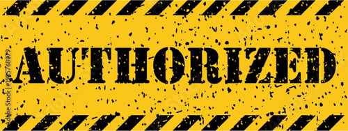 A weathered yellow and black striped sign clearly communicates the important word AUTHORIZED permission