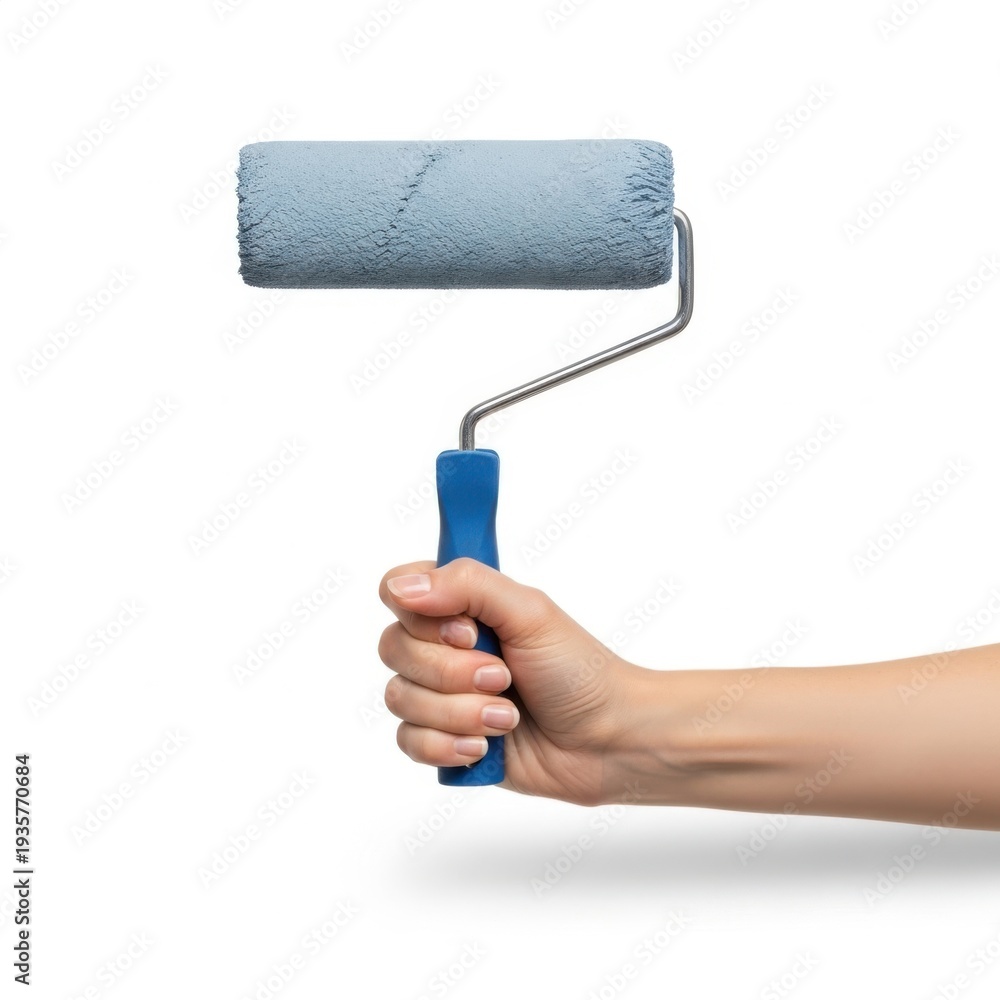 Obraz premium Hand holding a blue paint roller with a partially painted roller cover. isolated on white background