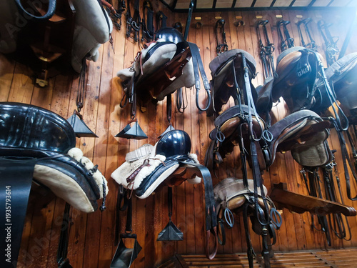 Billede på lærred Wide assortment of equestrian tack and saddles in vintage wooden stable
