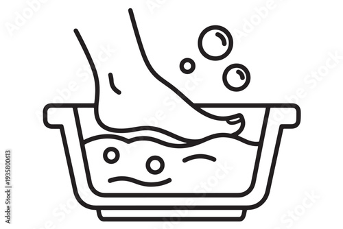 A person's foot soaking in a warm bath with bubbles