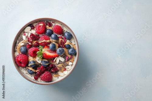 minimalist healthy breakfast bowl with fresh berries, chia seeds, almond butter drizzle