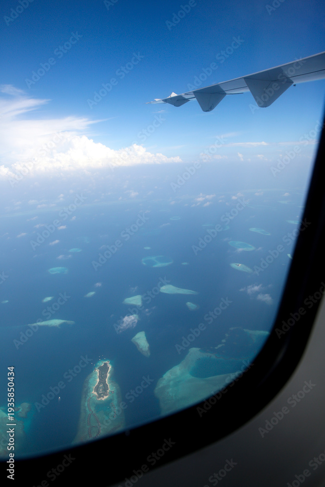 Fototapeta premium Looking Through Plane Window at Maldives Islands from Above