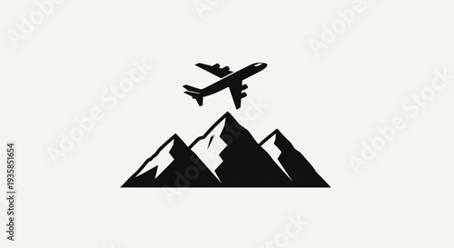 Airplane flying over mountain peaks silhouette.