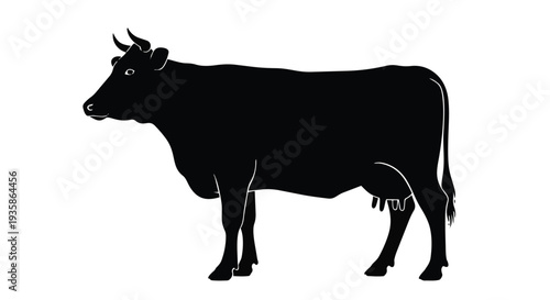 Black silhouette of a cow standing with horns and tail