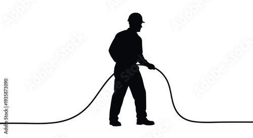 A worker in a hat and jacket pulls a long dark rope across a bright white background silhouette