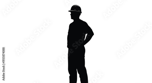 A stark black silhouette of a construction worker standing with hands on hips showcasing a powerful visual contrast silhouette
