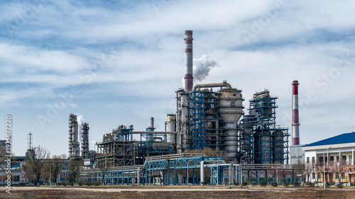 Industrial Petroleum Refinery Exterior View with Smokestacks