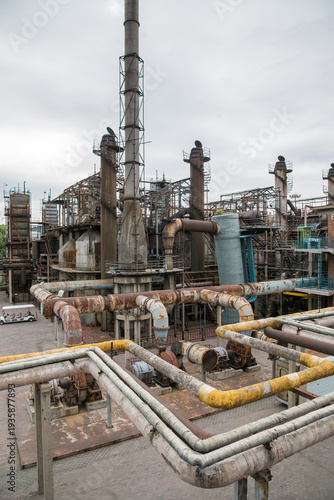 Abandoned Industrial Factory with Rusted Pipes and Chimneys