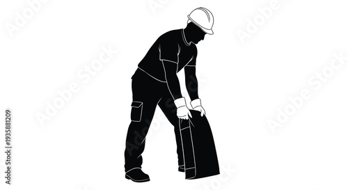 A construction worker in a helmet bends to lift a heavy object depicted as a striking silhouette high quality