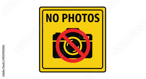 Close-up of a yellow sign with a red prohibition symbol over a camera, indicating no photos are allowed.