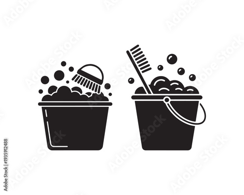 Two black silhouette buckets filled with soap bubbles and cleaning tools symbolizing household chores and cleaning services