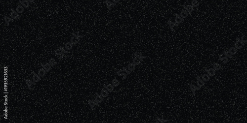 Dark speckled texture background with subtle gray granular pattern for abstract design and grunge effects
