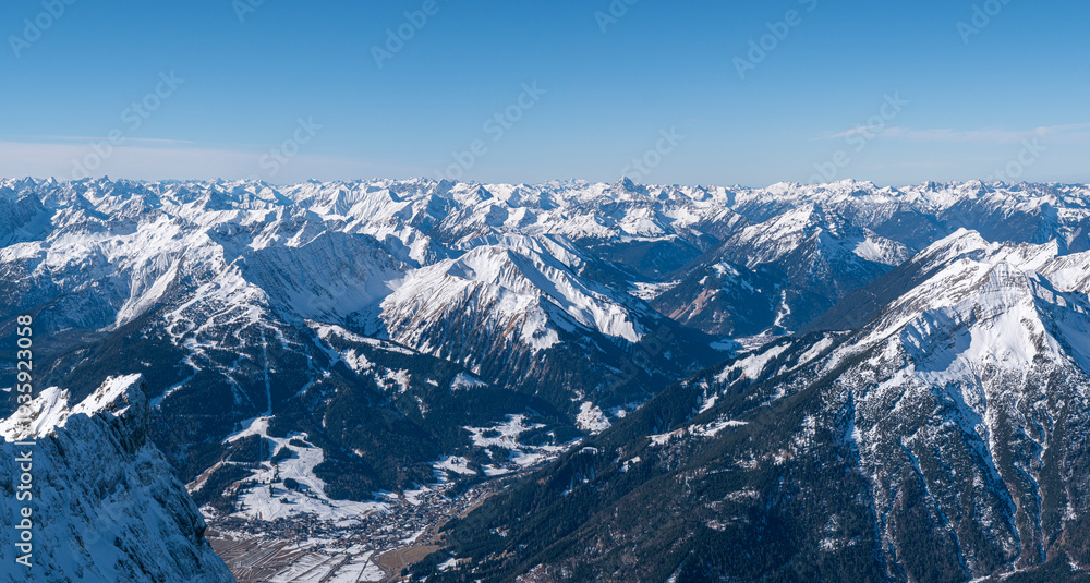 Fototapeta premium Breathtaking high-angle panorama of snowy mountain peaks and a ski resort valley in the Tyrolean Alps, Austria