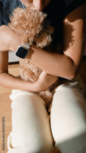 Tranquil moment where woman attentively looks after her playful puppy