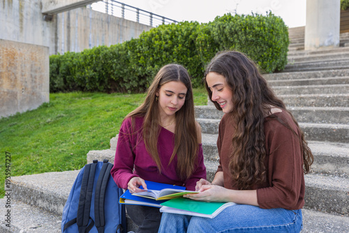 Teen girls studying together discussing schoolwork outdoors