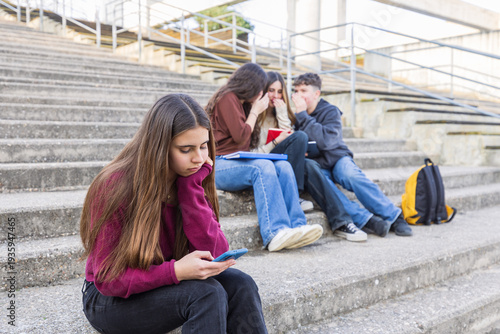 Teenage girl experiencing social exclusion from gossiping peers