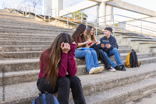 Sad teenage girl feeling excluded from her schoolmates