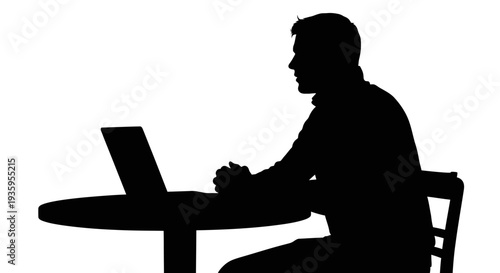 Man sitting at table with laptop.