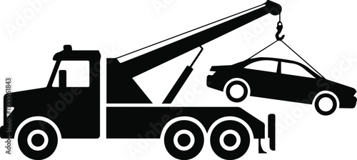 Wrecker recovering truck from highway after collision