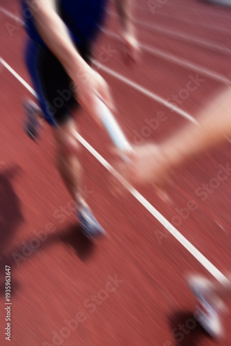 Canvas Print Dynamic motion blur of baton handoff in relay race, speed and precision in track and field training