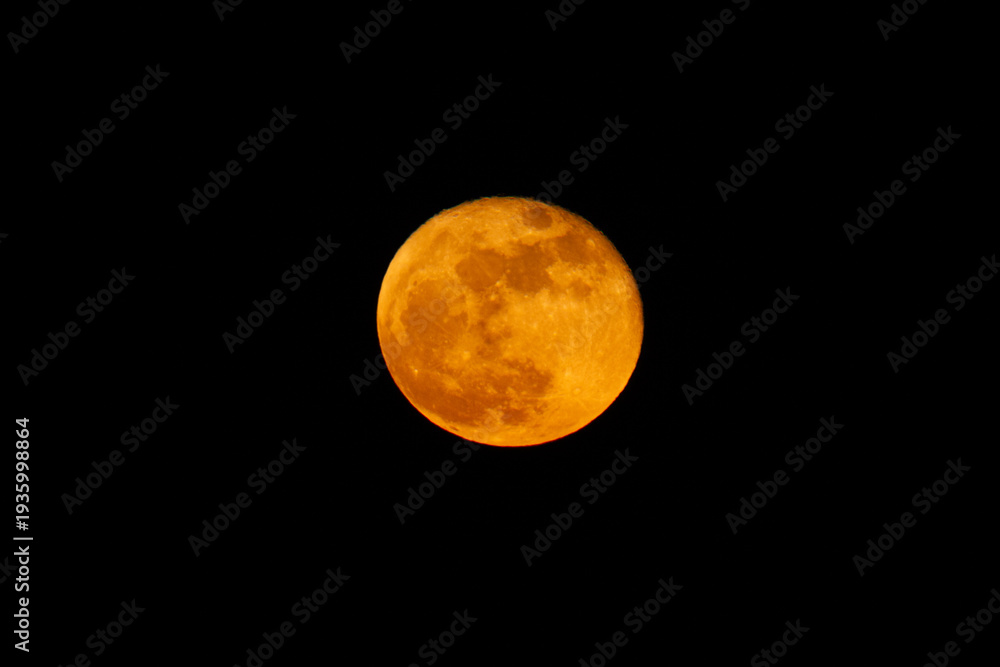 Obraz premium Lunar eclipse, causing the Moon to appear orange or red