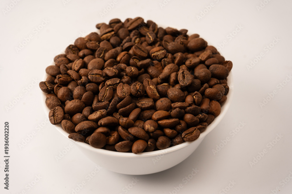 Fototapeta premium Coffee beans on a white background. Top view. Coffee beans texture.