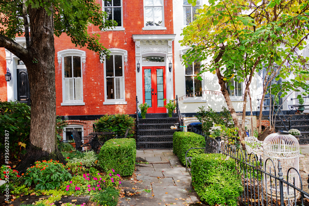 Fototapeta premium Washington DC residential street featuring red brick townhouse and fall foliage