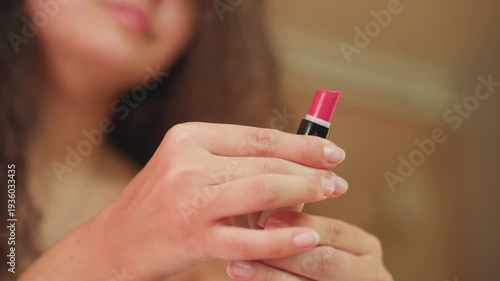 Elegant lady preparing herself for evening date. Female individual beautifying herself for romantic night out. Caucasian woman dressing up in hotel room for intimate romantic dinner