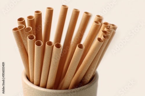 Eco-friendly bamboo straws arranged neatly in a cylindrical container, perfect for beverages, representing a commitment to sustainability and a lifestyle choice.