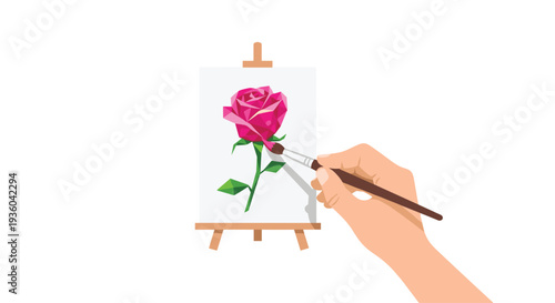 A human hand holds a brown paintbrush, adding detail to a vibrant pink polygonal rose with a green stem on a small wooden easel.