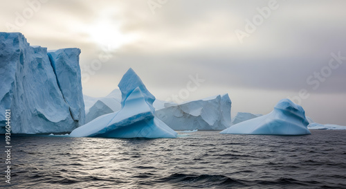 A serene landscape of icebergs floating in the ocean under a cloudy sky
