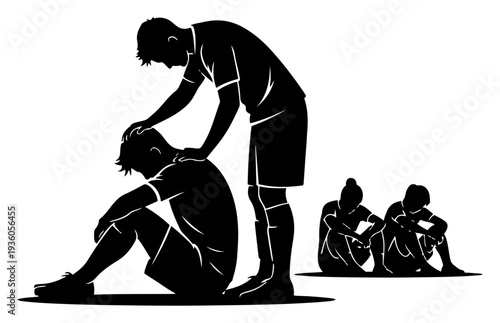 Defeated soccer player sitting on the ground being comforted by his teammate