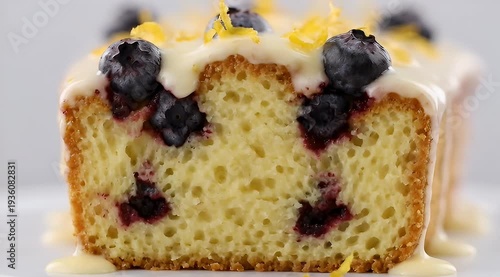 Close up view of a delicious slice of blueberry lemon cake with frosting