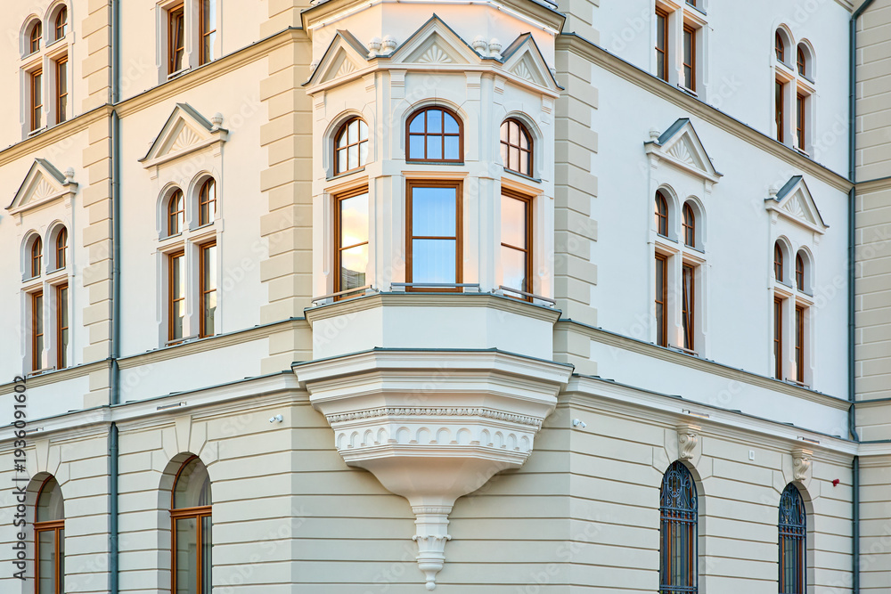 Obraz premium Elegant architectural details of historic european building with ornate windows