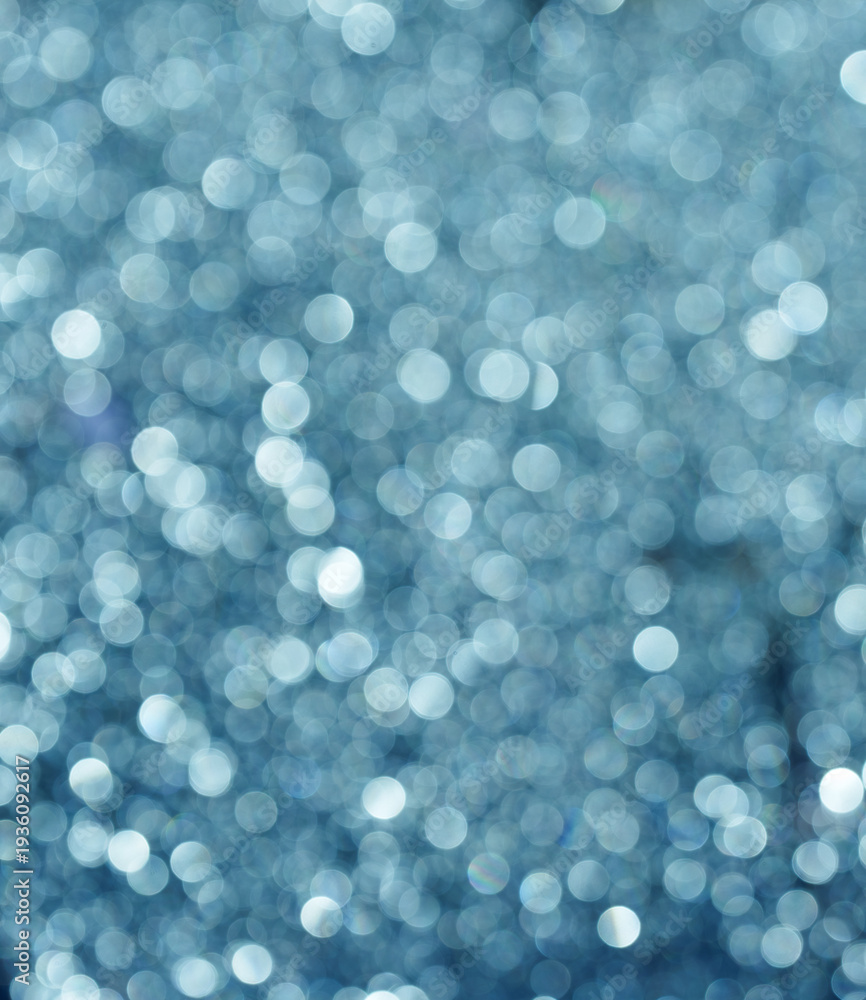 Obraz premium Blue glitter bokeh background with sparkling light circles
