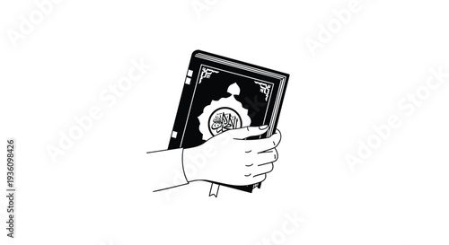 A hand holds a black book with Arabic calligraphy on the cover