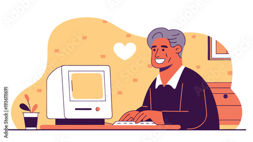A smiling senior man with grey hair types on a vintage white desktop computer monitor at a desk featuring a small potted plant and a heart on the wall.