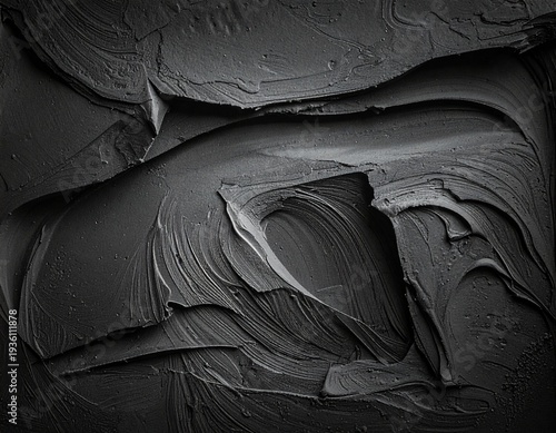 Dark, textured surfaces swirl with depth and contrast
